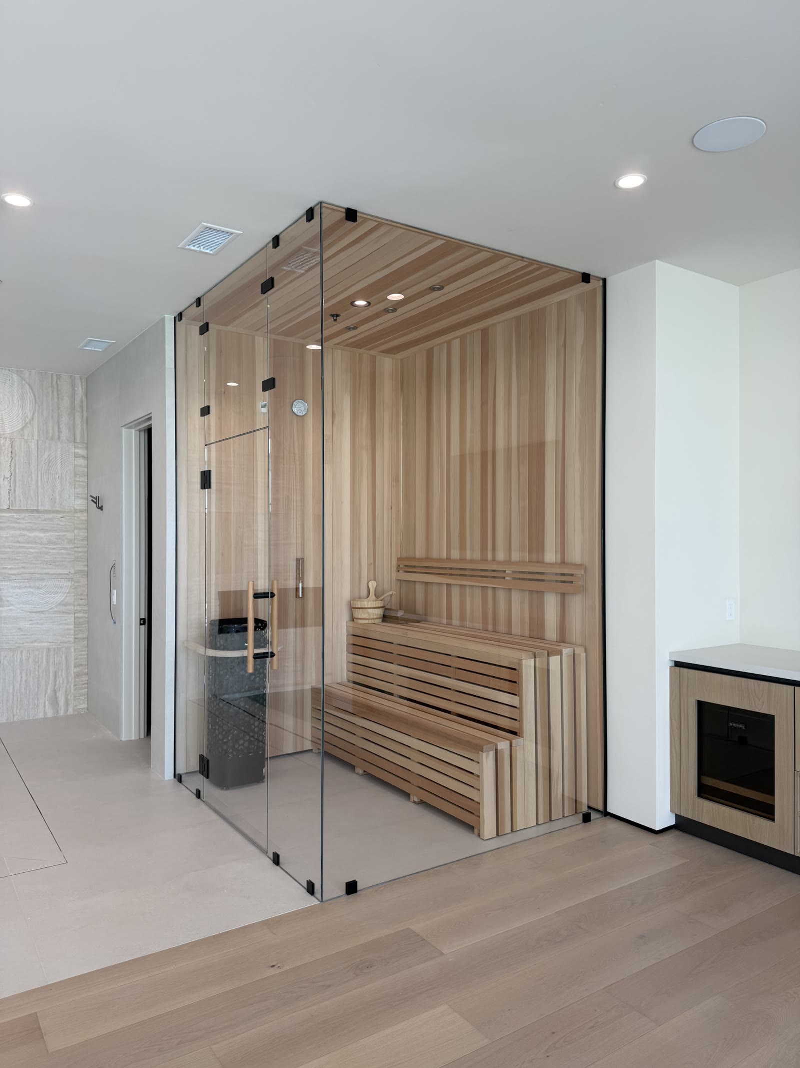 Custom glass-front cedar sauna built by 4x8 Construction
