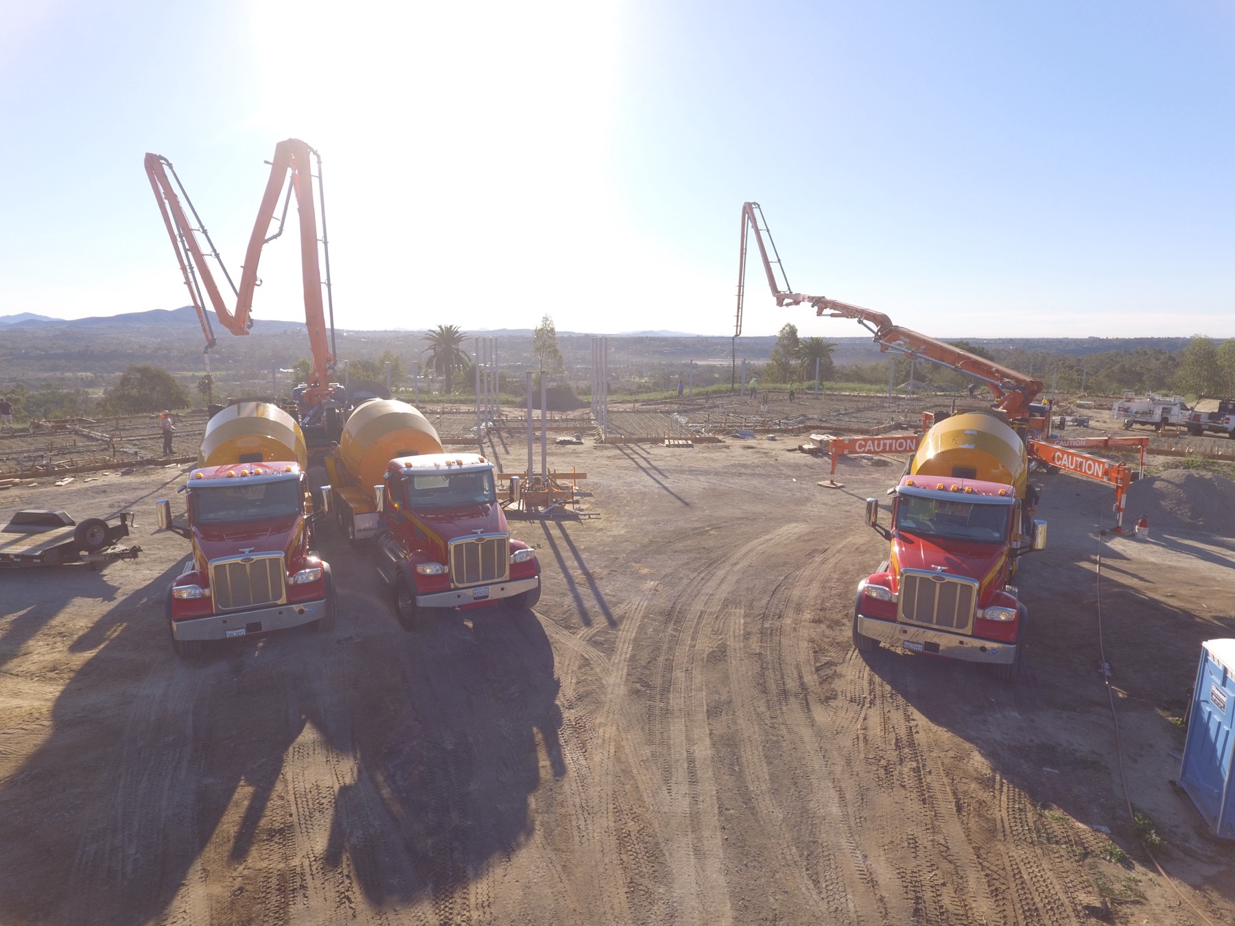 Drone aerial of the 4x8 foundation pour at Linea Del Cielo — footings, stem walls and pump crews