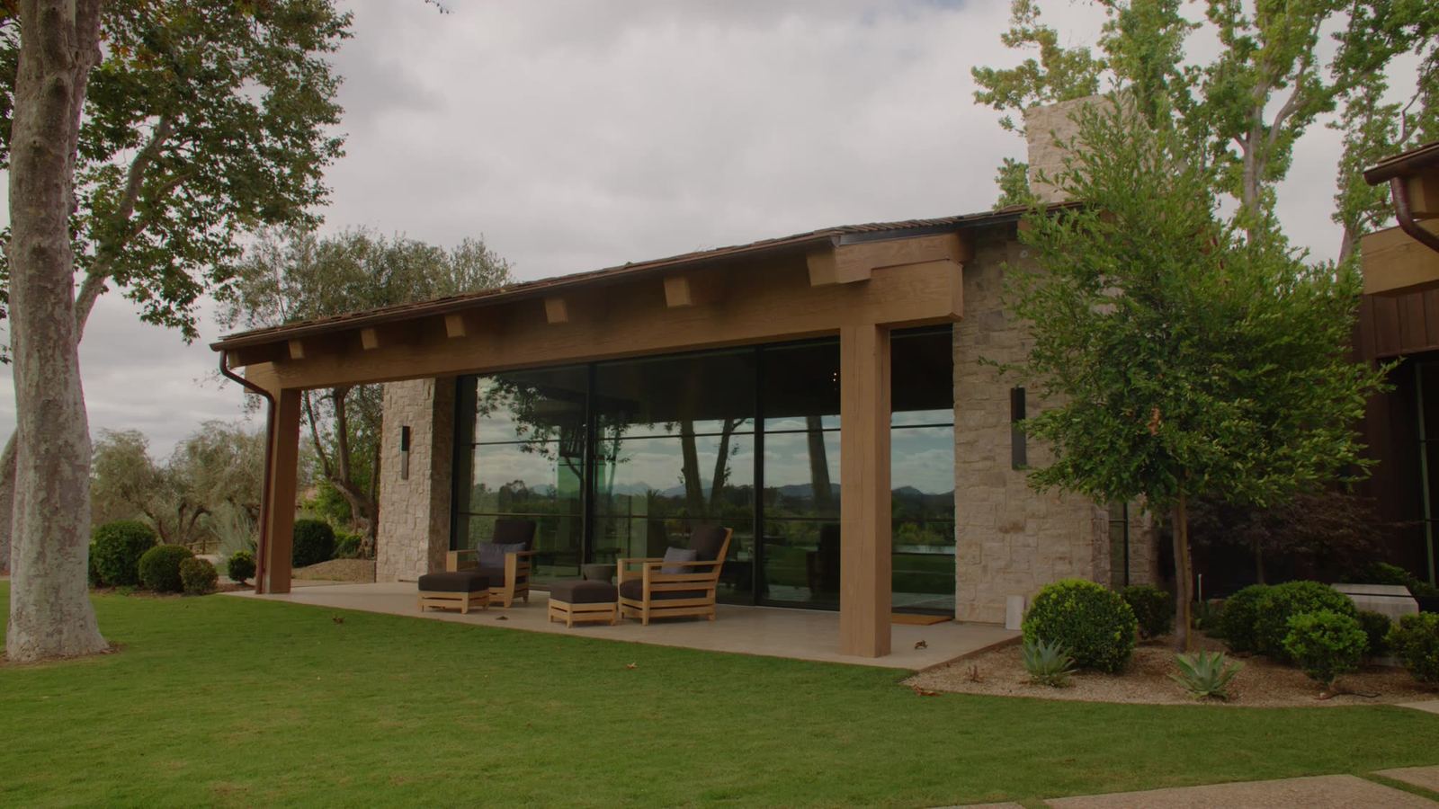 Covered terrace with exposed beam ceiling and concrete flatwork