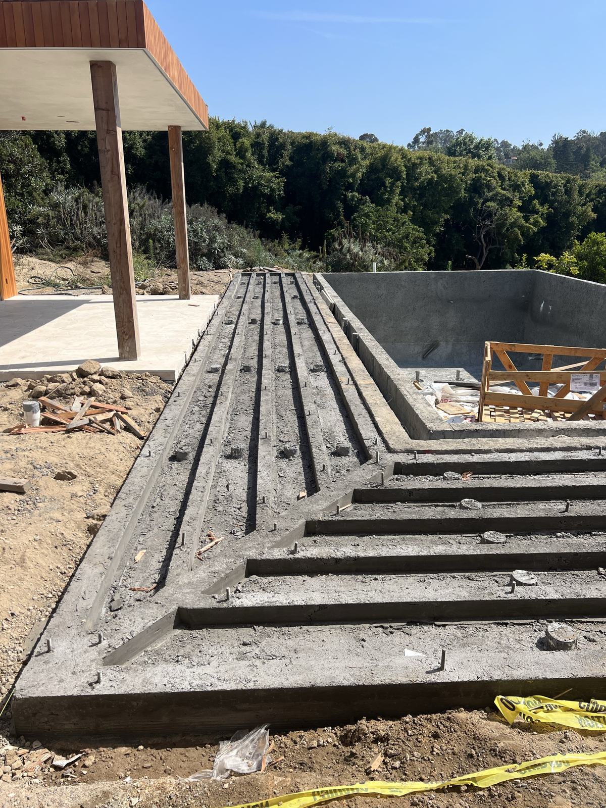 Stripped concrete stem walls showing the radiating deck structure