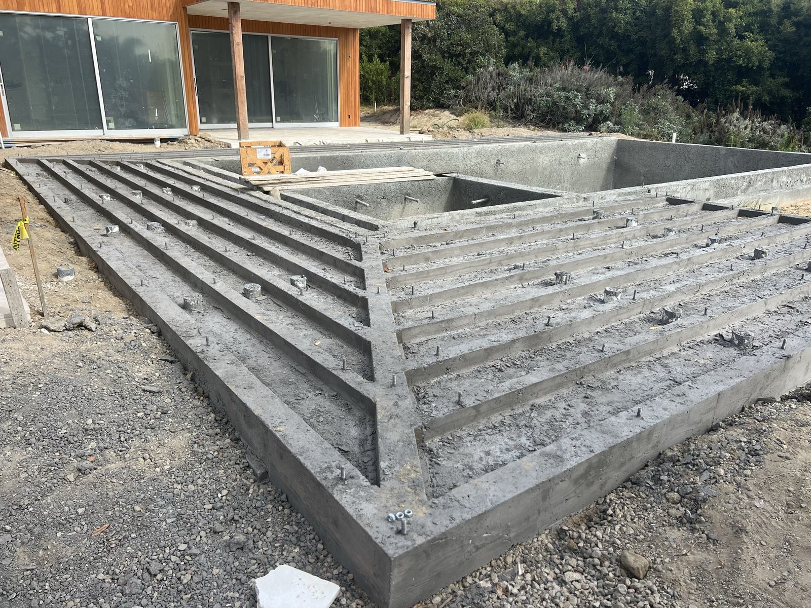Completed concrete stem walls and pool shell ready for deck framing