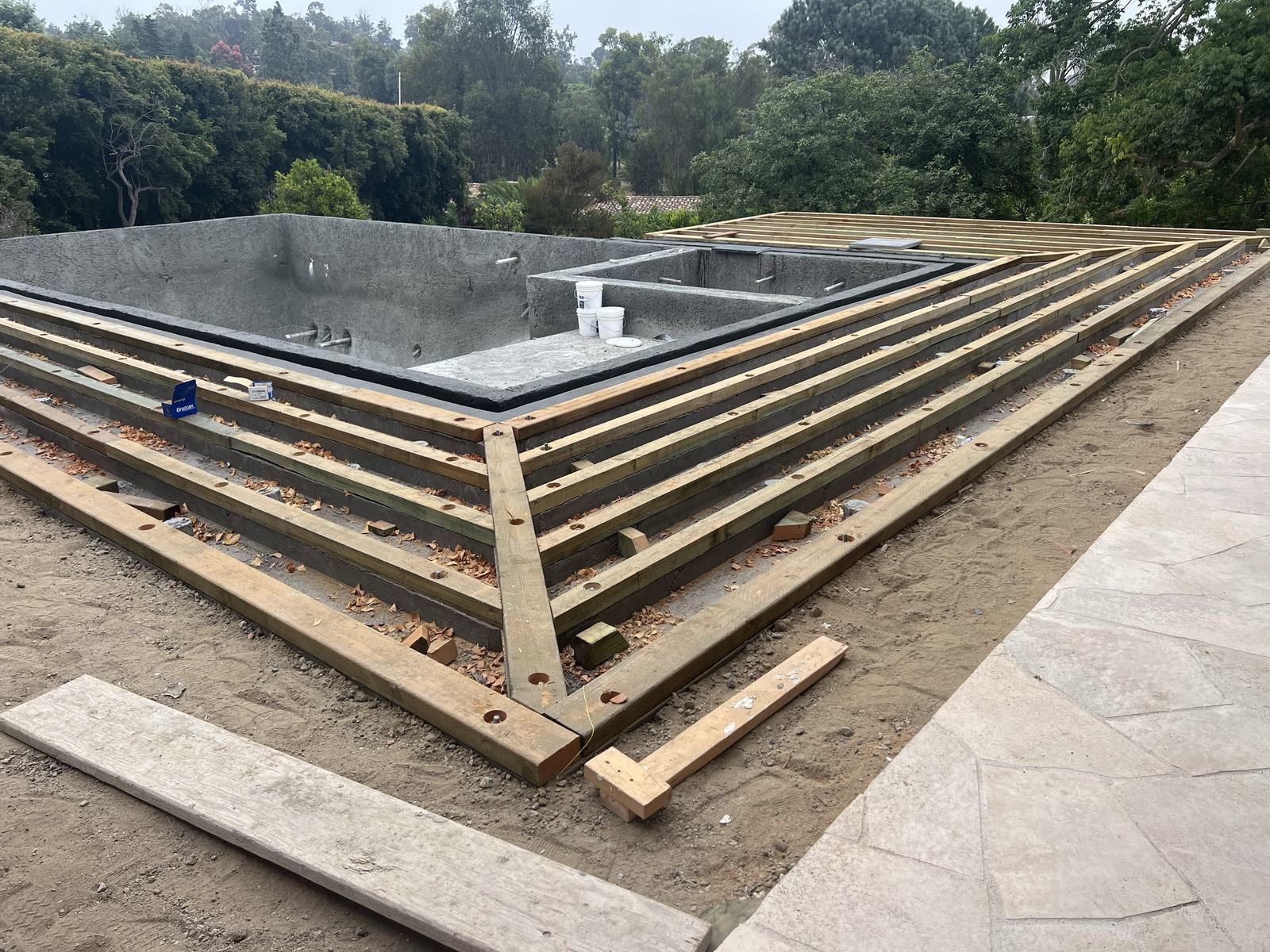 Deck framing running out to the pool coping