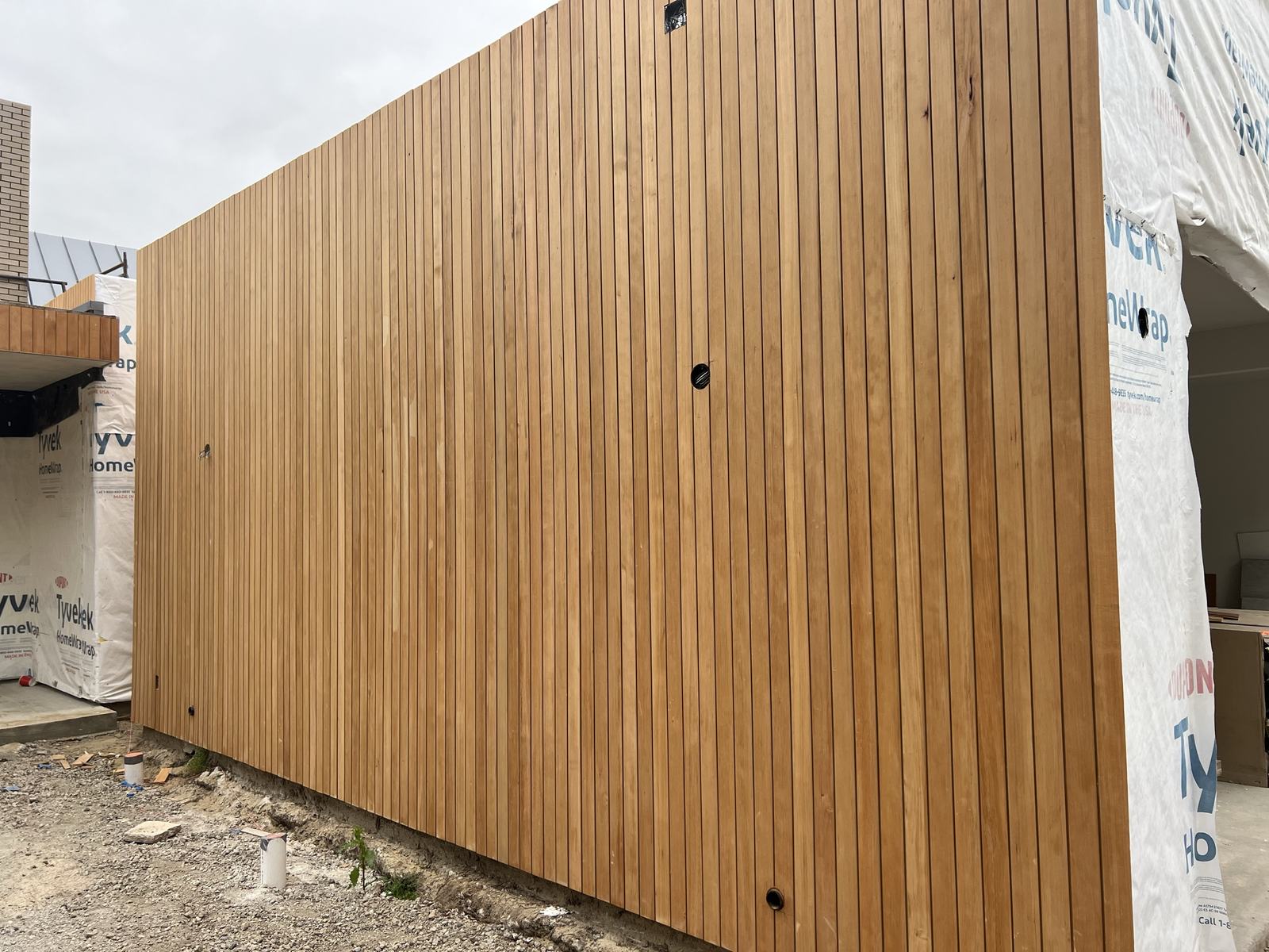 Four-inch vertical-grain cedar siding on the main elevation