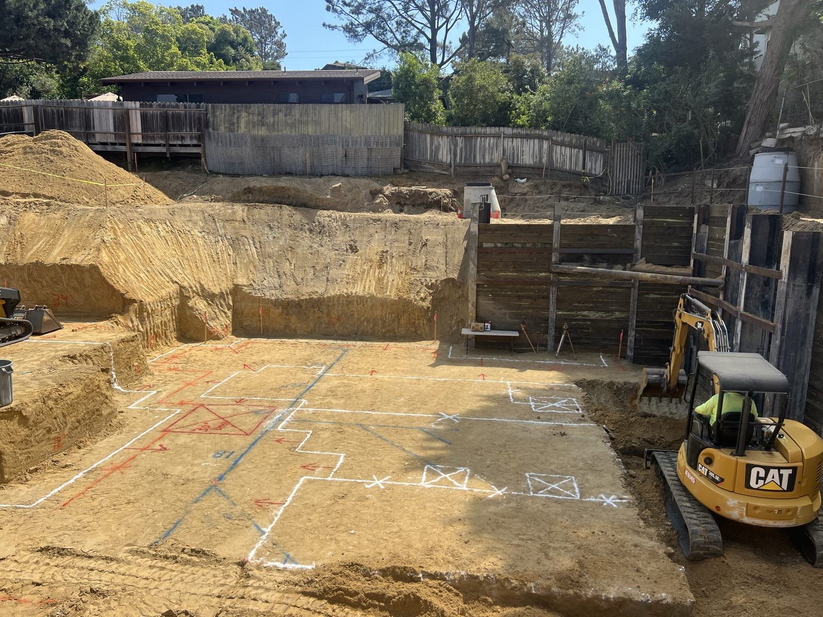 Foundation layout lines chalked on the excavation floor