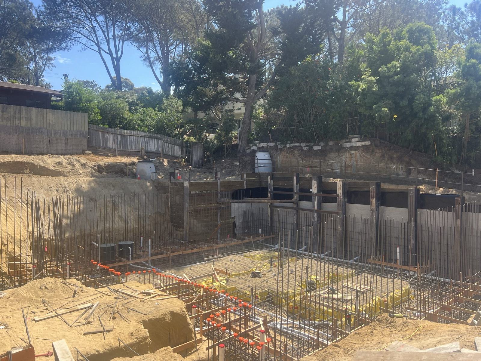 Basement foundation reinforcing steel laid out across the excavation