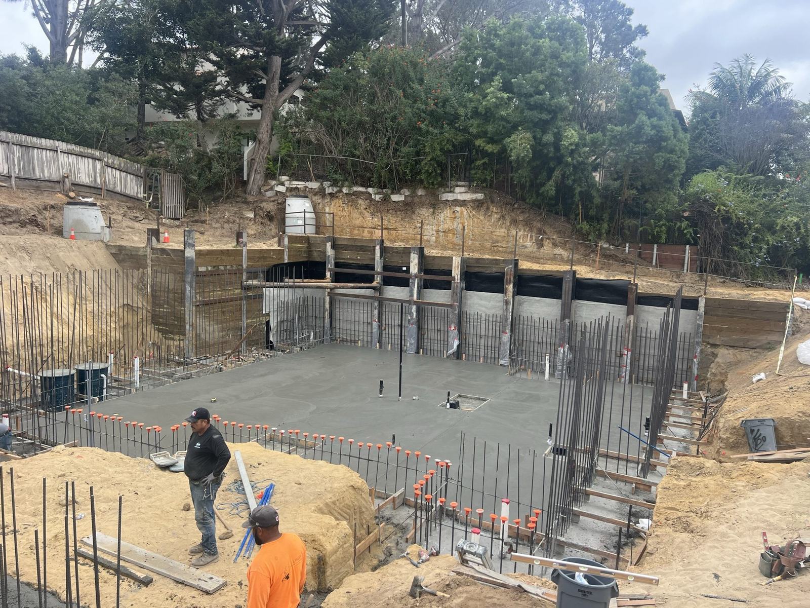Completed basement slab with wall reinforcing standing