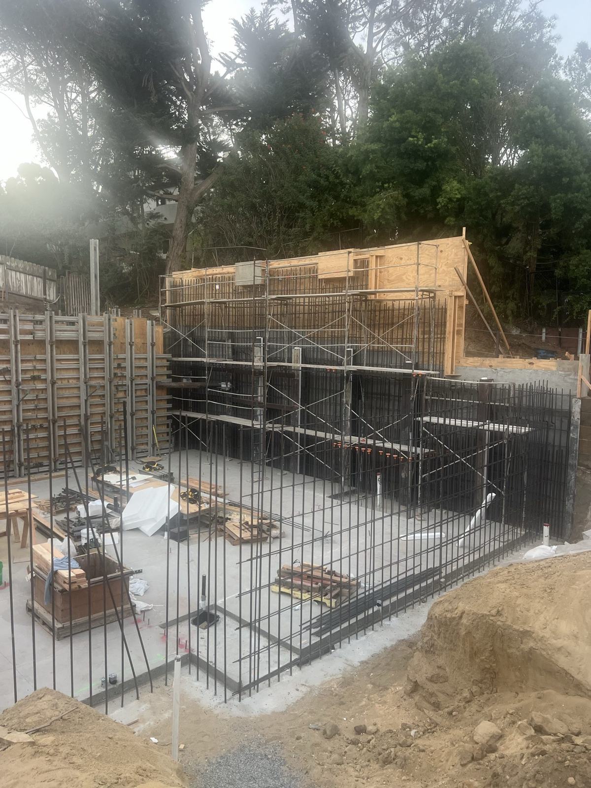 Basement wall reinforcing cages standing on the poured slab