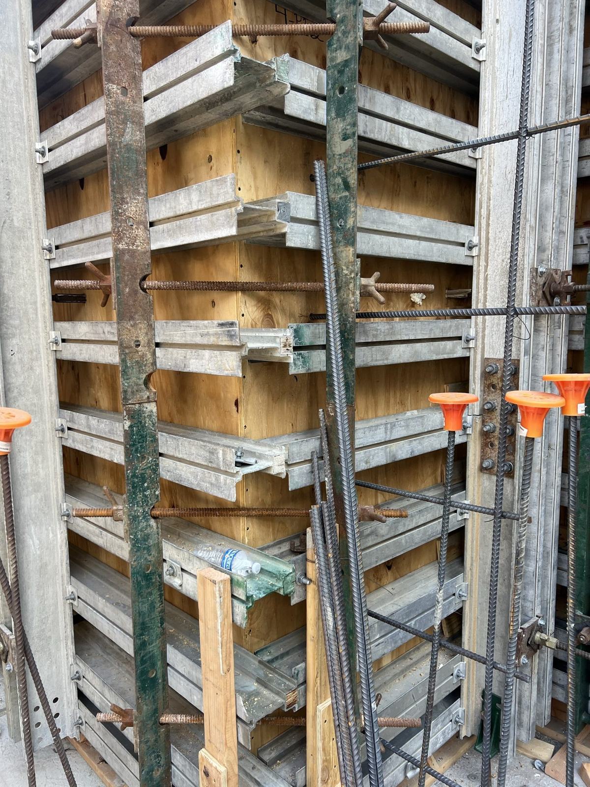 Gang form panels and walers on a cast-in-place basement wall