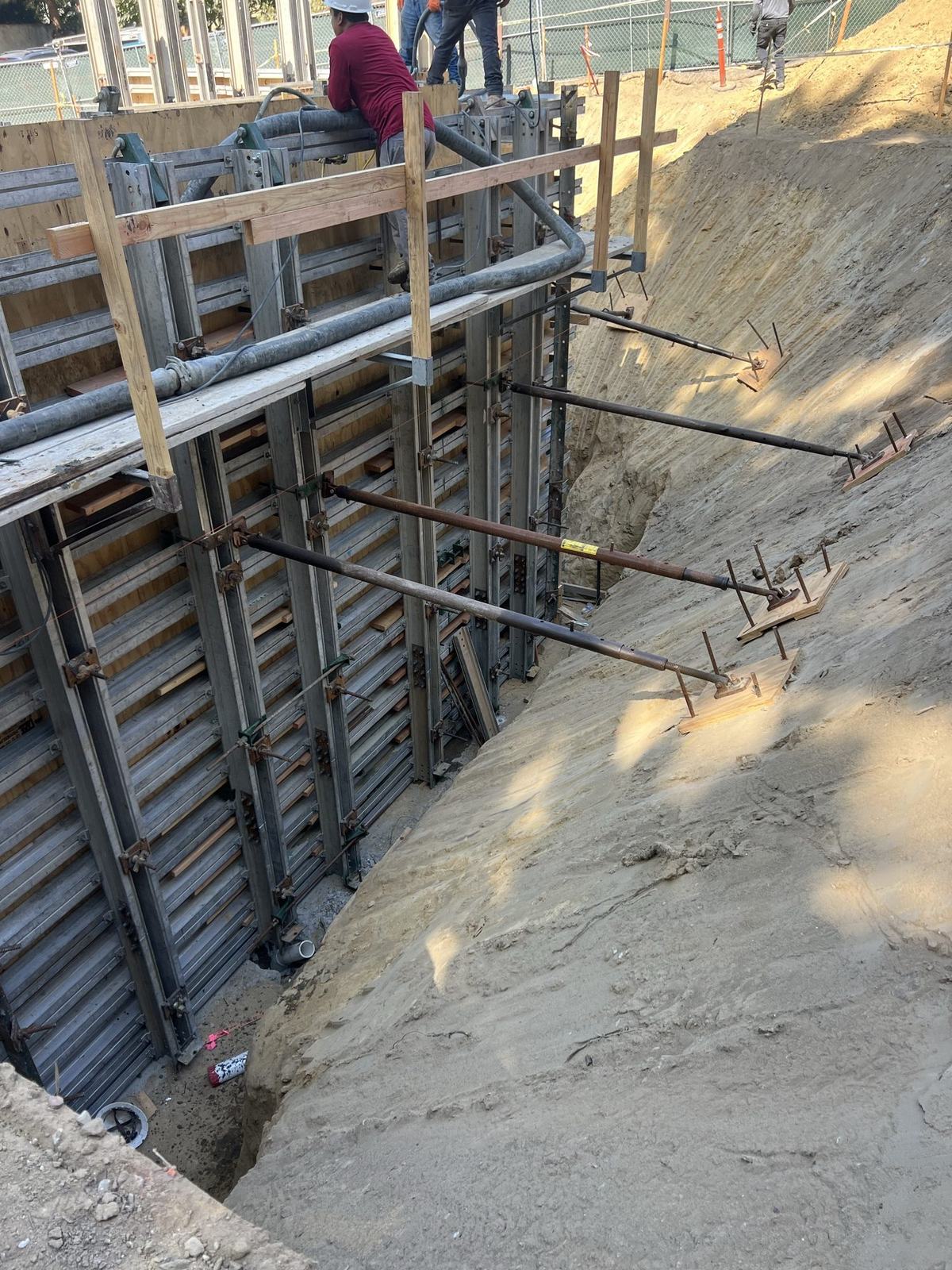 Braced wall forms stepping down the hillside excavation