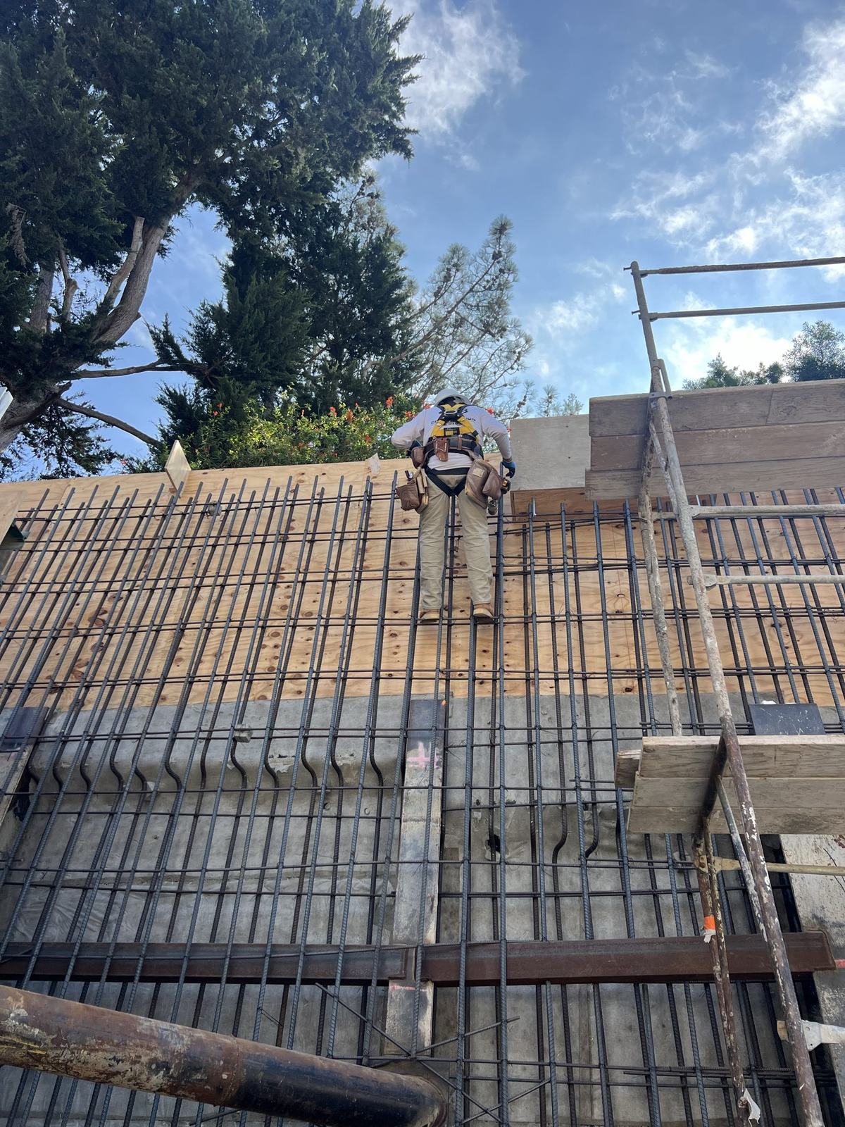 Crew member working the reinforcing mat above the basement wall