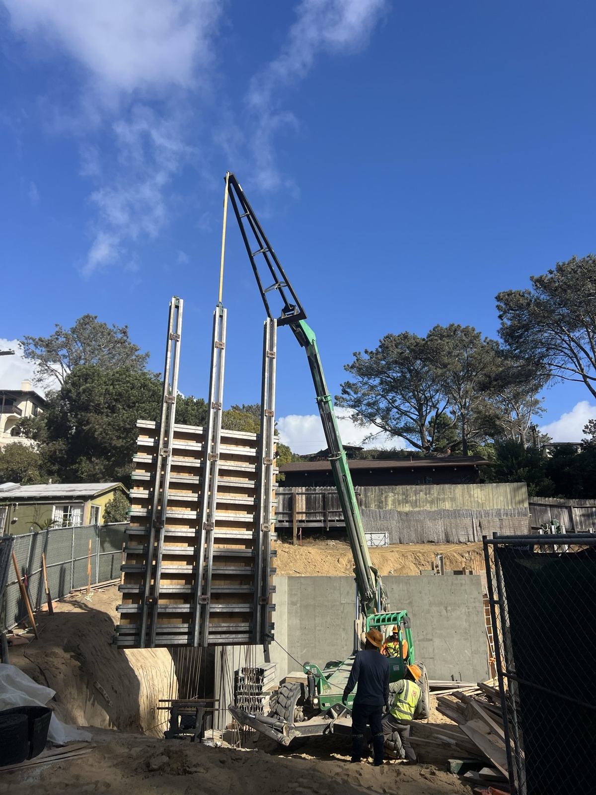 Telehandler flying a form panel into the basement wall