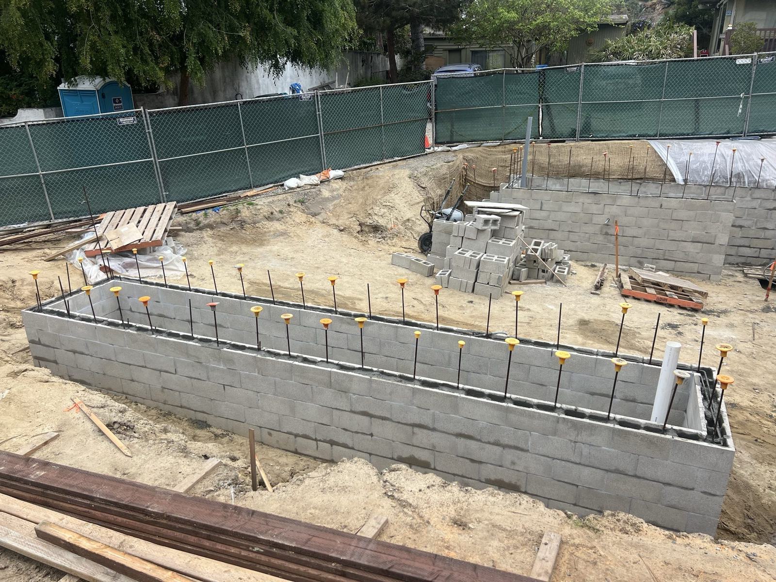 Block site wall with vertical reinforcing ready to grout