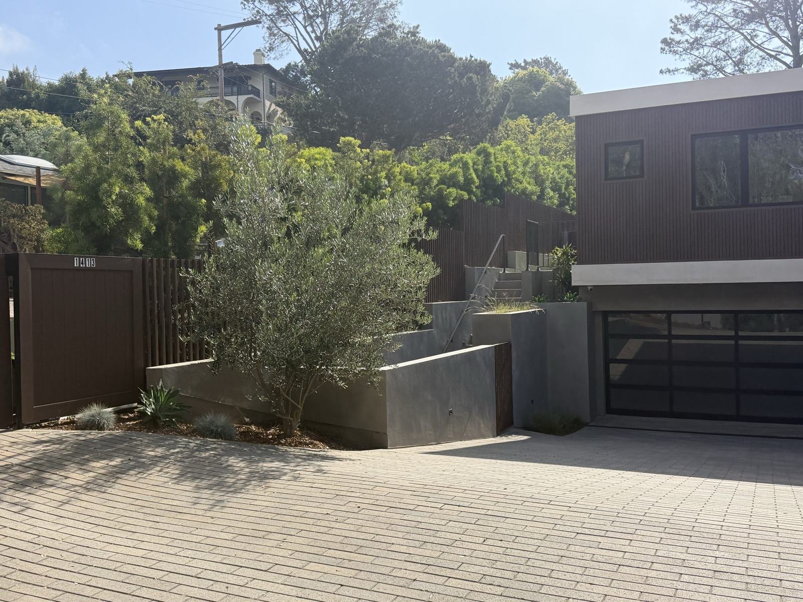 Motor court with olive tree and concrete planter walls, Del Mar