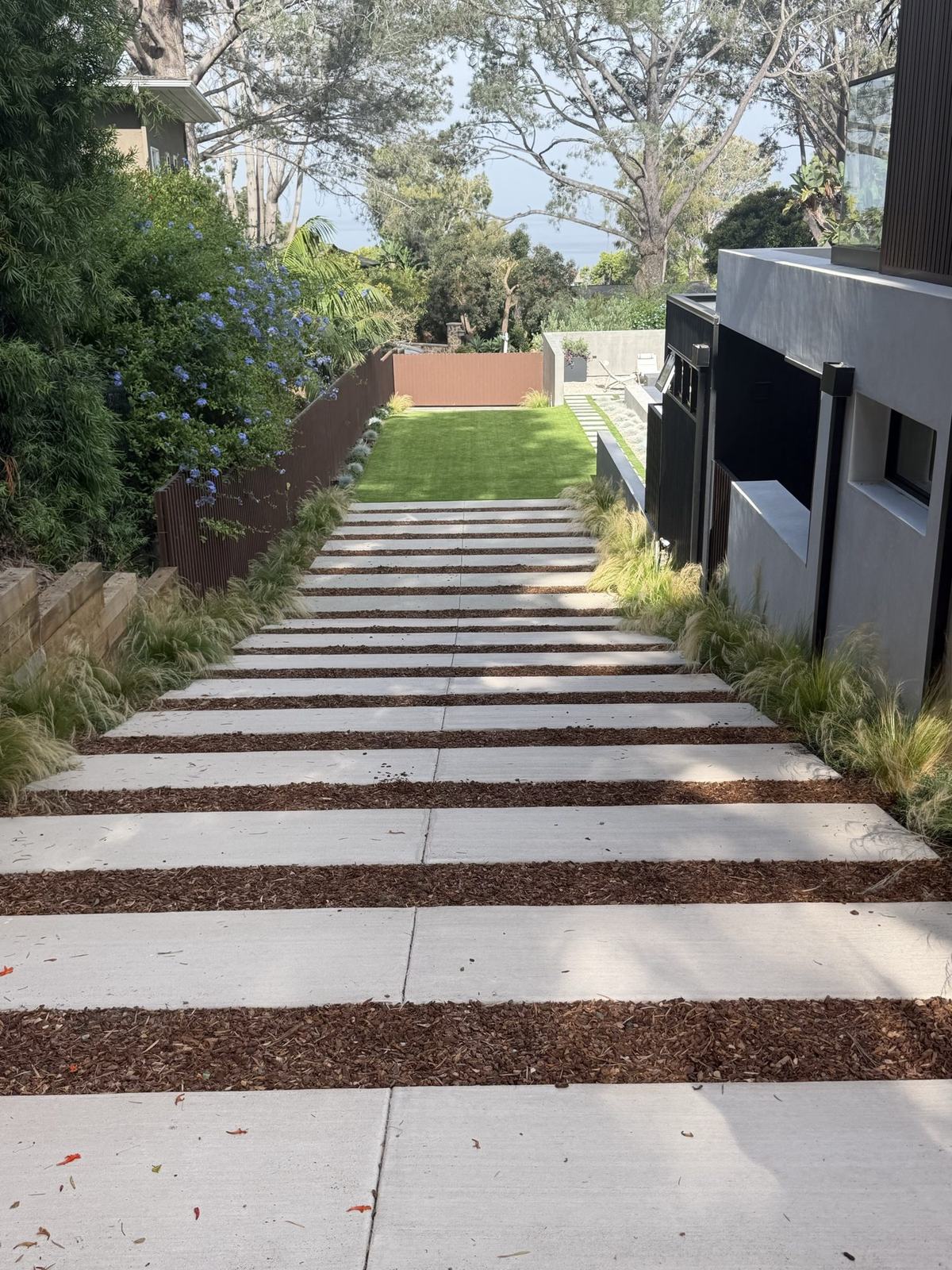 Finished paver walkway and turf panel along the side yard