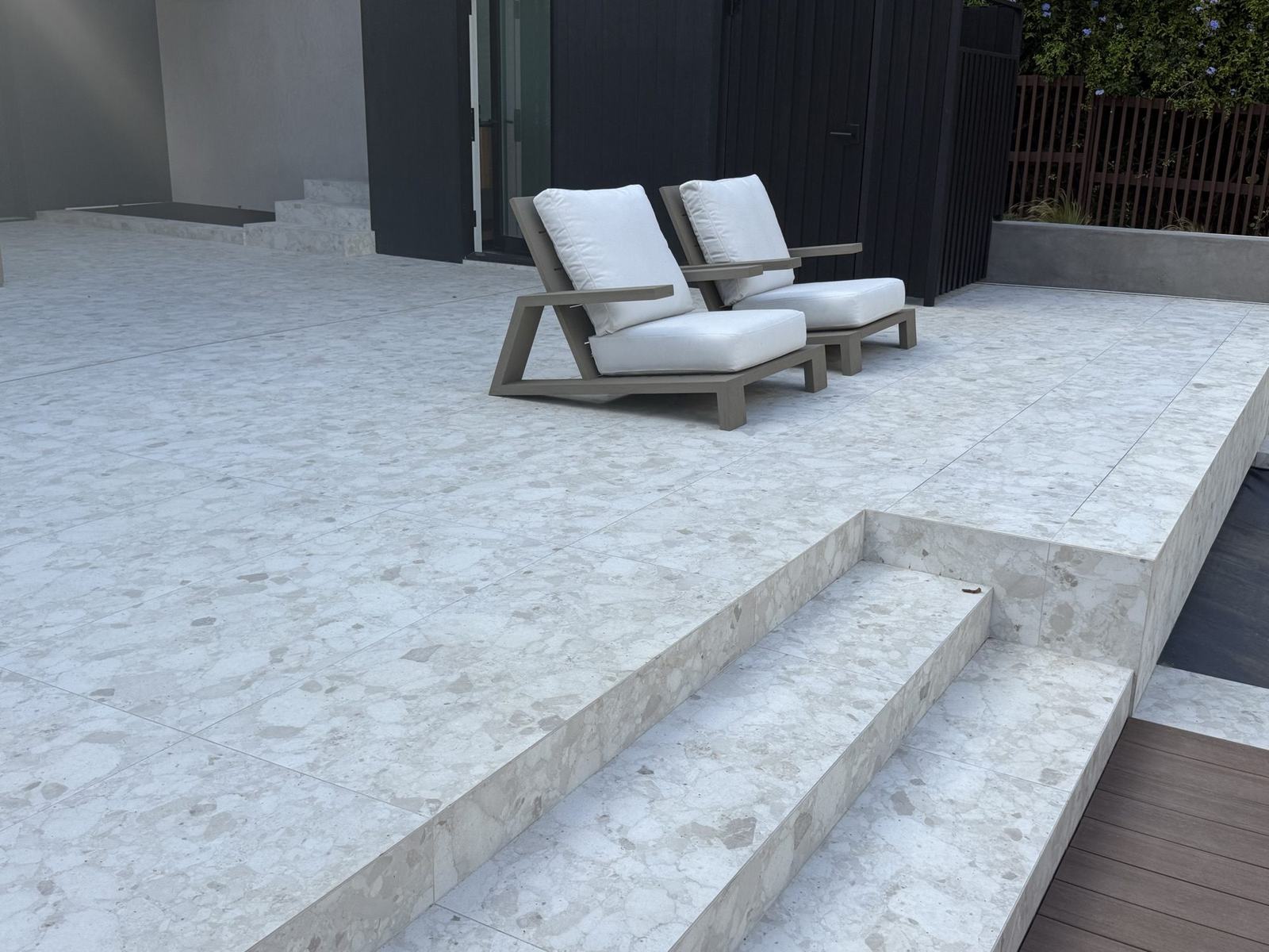 Finished stone terrace and steps off the main living level